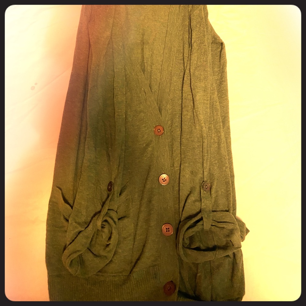 Green cardigan with buttons.